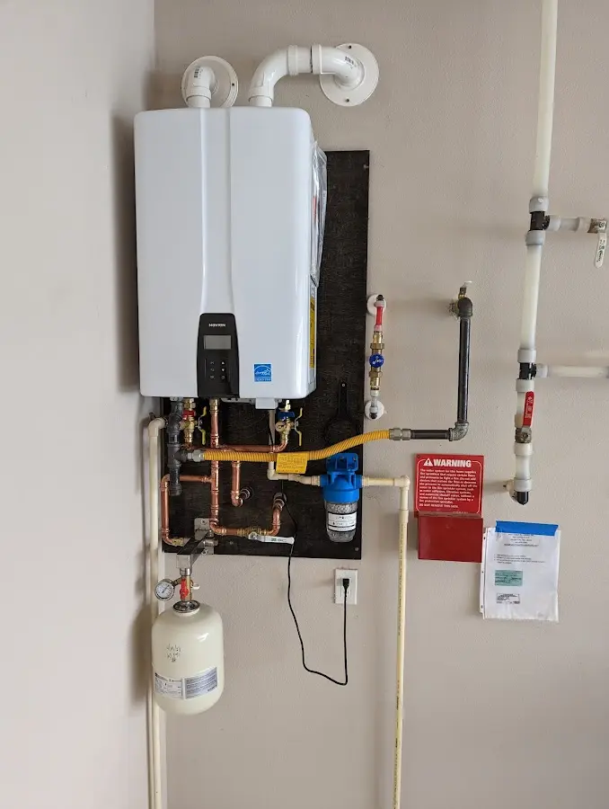 Professional plumber installing copper piping in a Woodville home